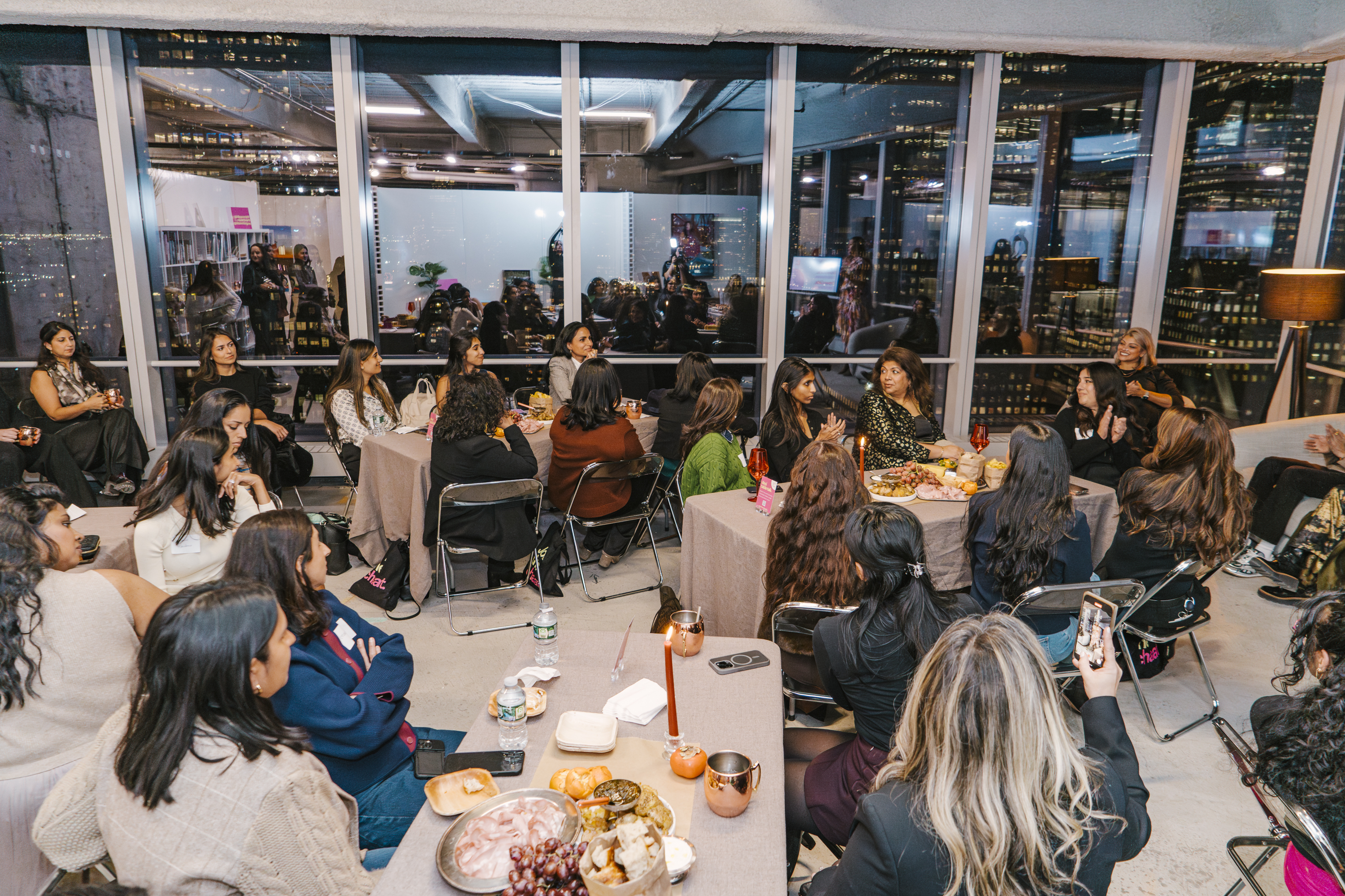 A wide shot of the Brown Girl Angels SickKids fundraiser in New York — the full room, the skyline, the community.